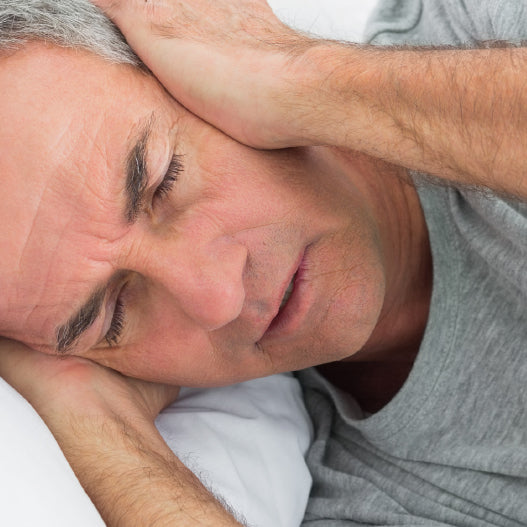 Man being kept awake by snoring